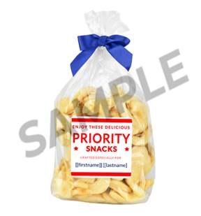 A bag of snacks with a blue bow

Description automatically generated